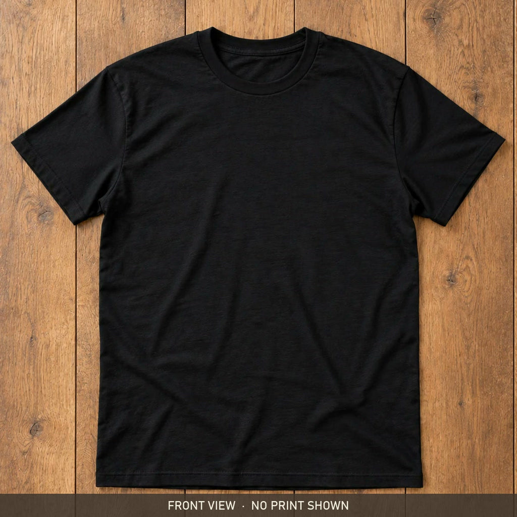 Black Gildan Softstyle 64000 t-shirt, front, flat lay on a wooden floor
