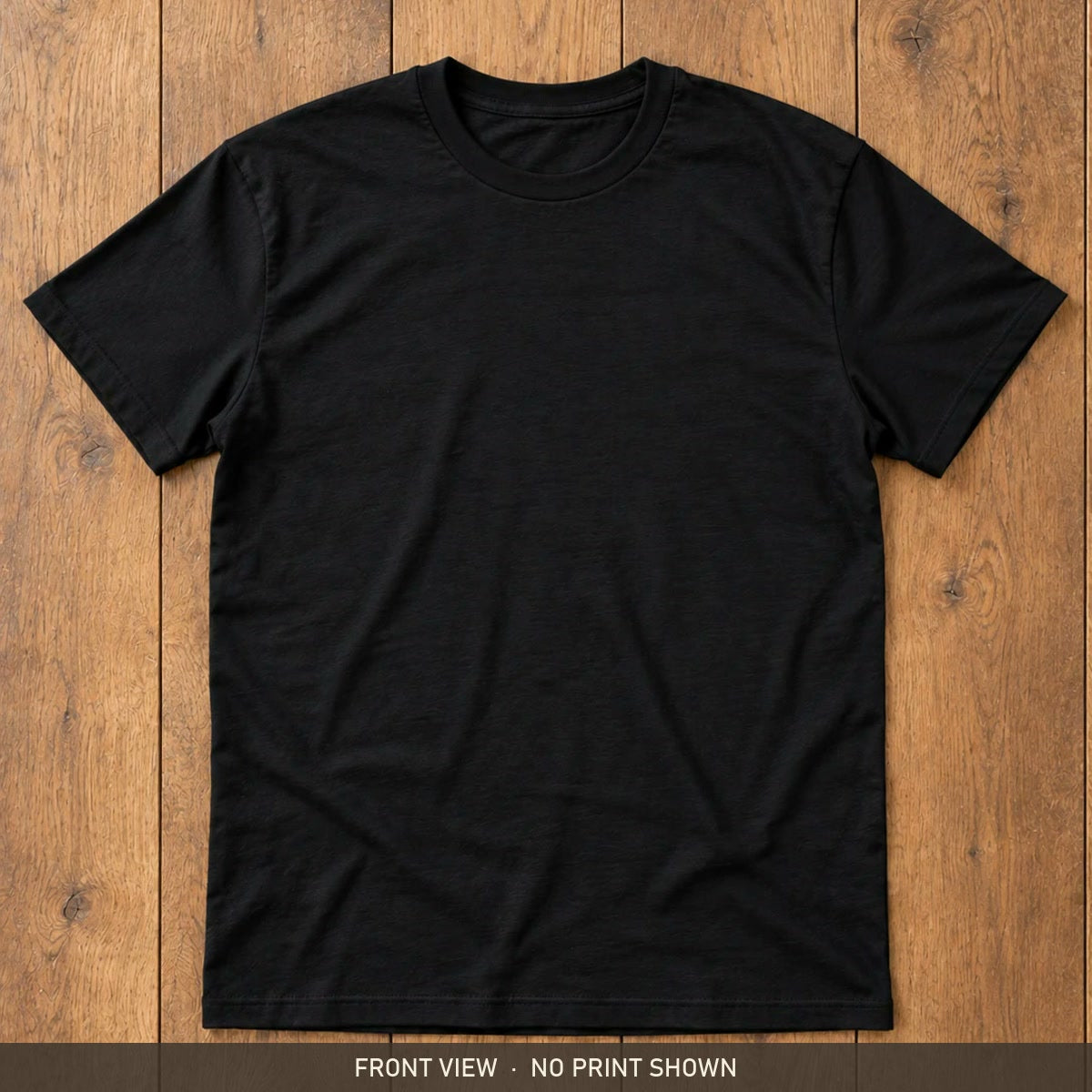 Black Gildan Softstyle 64000 t-shirt, front, flat lay on a wooden floor