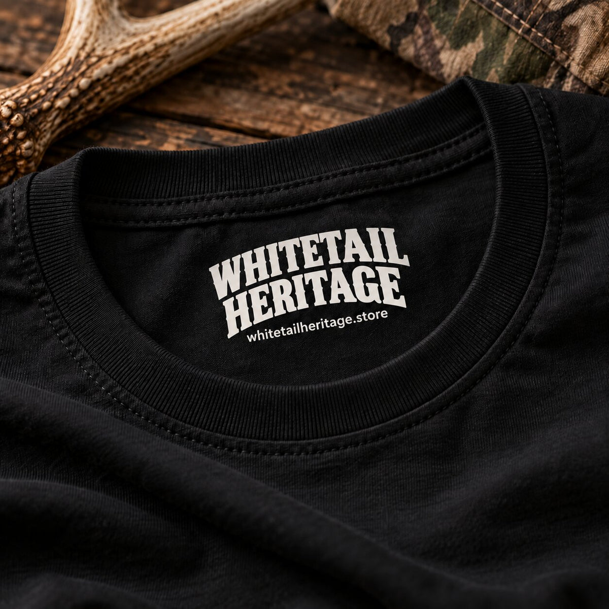 Whitetail Heritage neck tag closeup on black tee